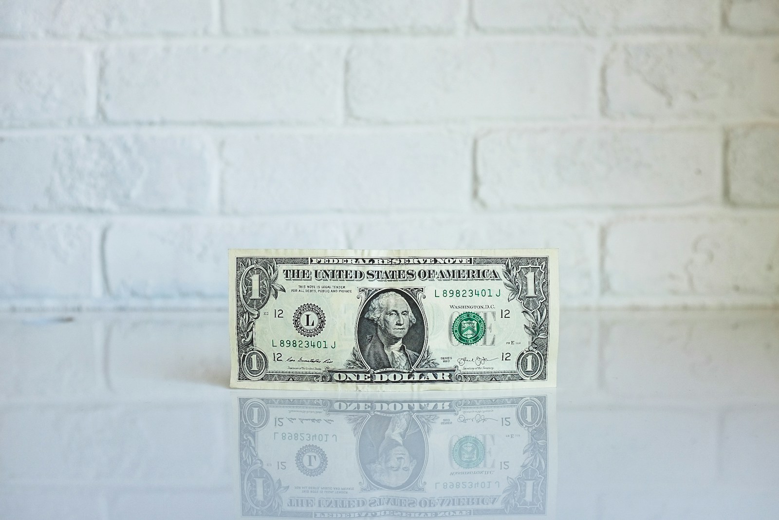 Photo by Kenny Eliason 1 U.S. dollar banknote on white surface